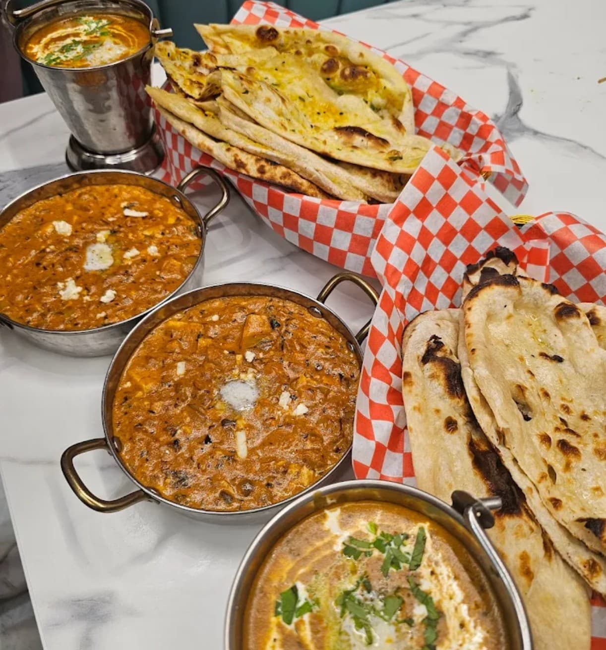 Assorted vegetarian Indian dishes including dosa and chana bhatura